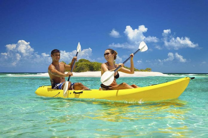 Two people paddling together in a double kayak
